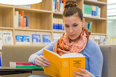 SRH international student studying library book